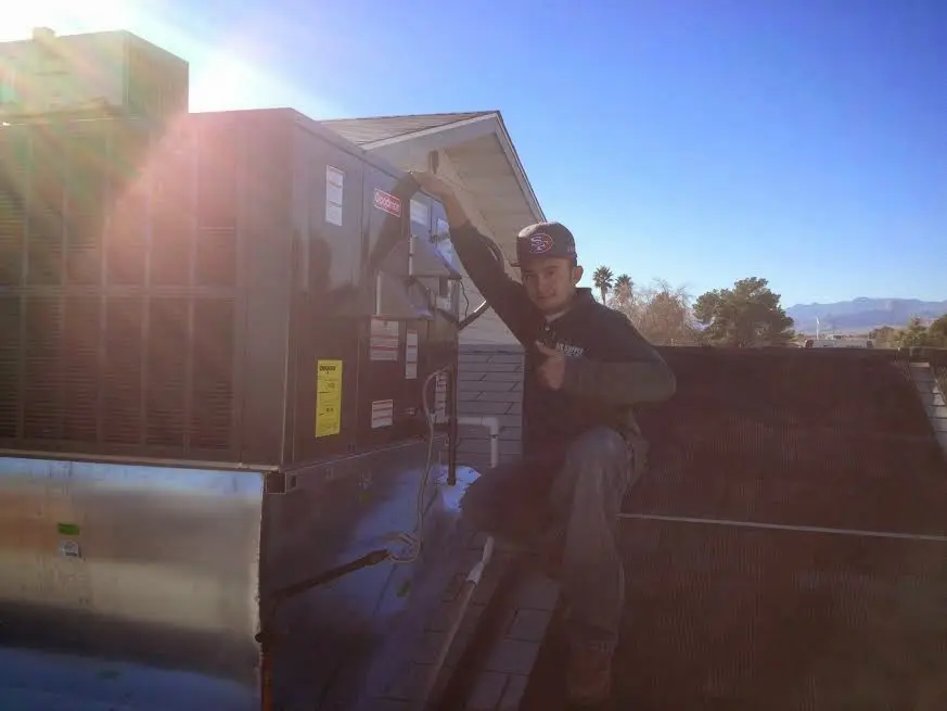 HVAC technician performing Boiler Repair on a rooftop unit in Marion Oaks
